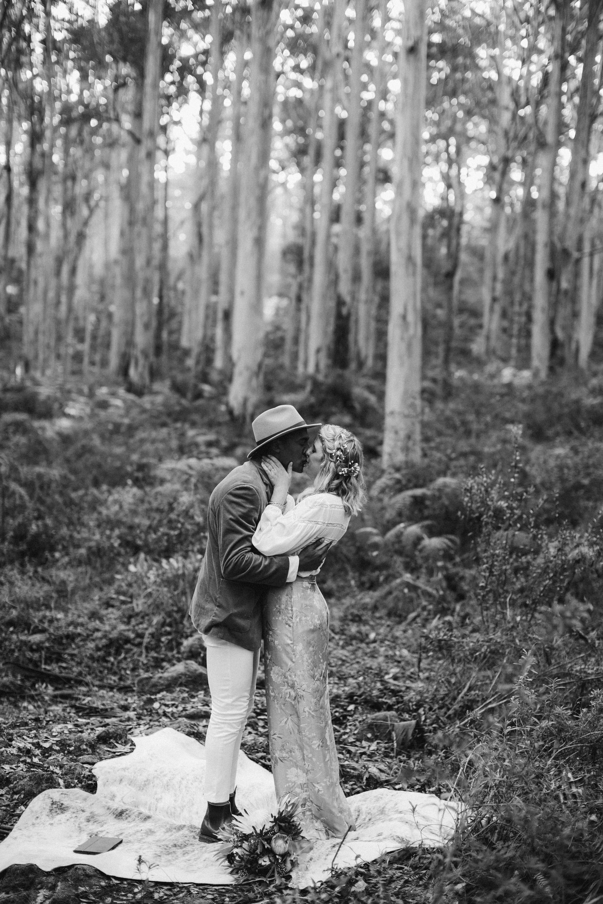 black and white photograph couple kissing in boranup forest