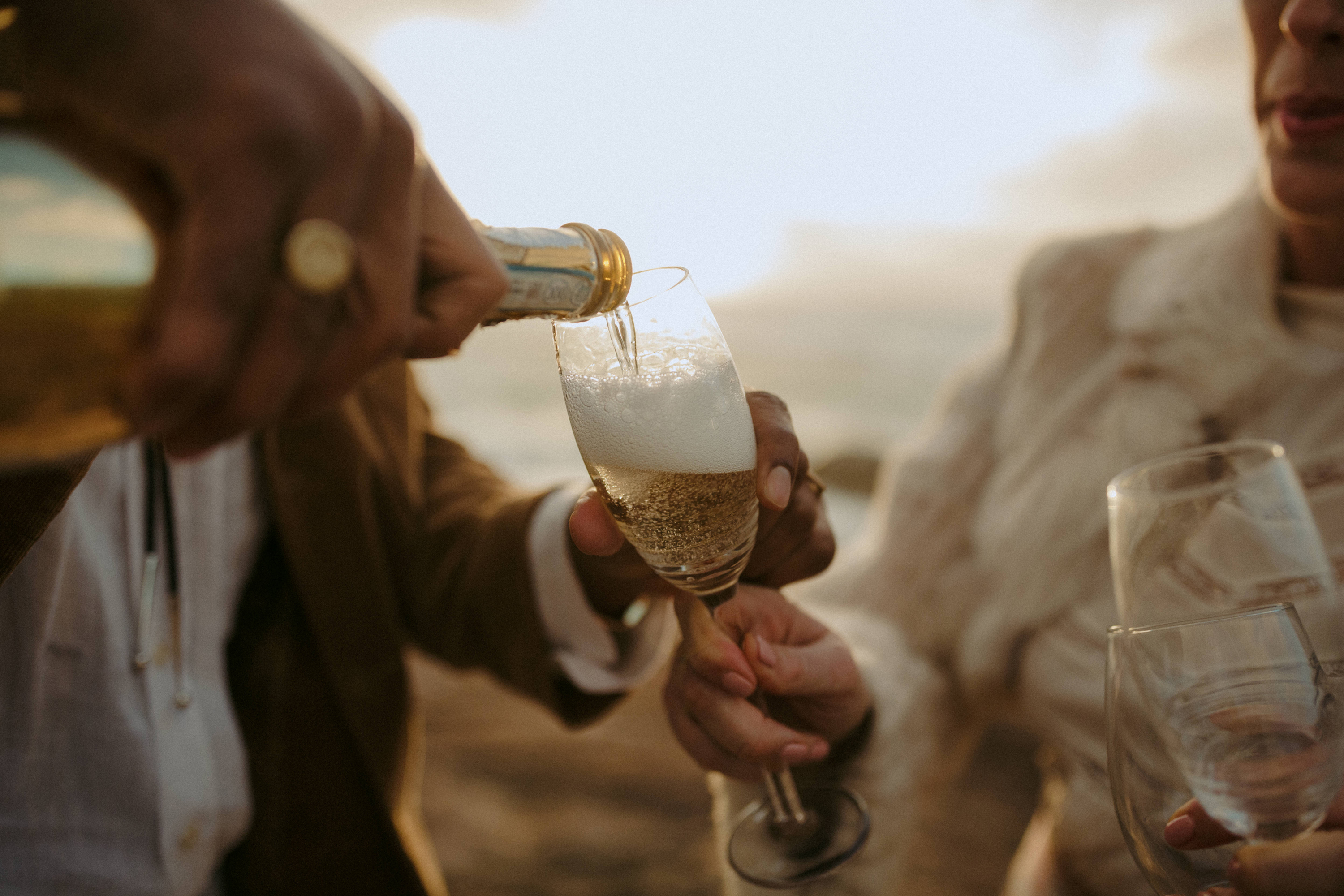 bride and groom pouring champagne