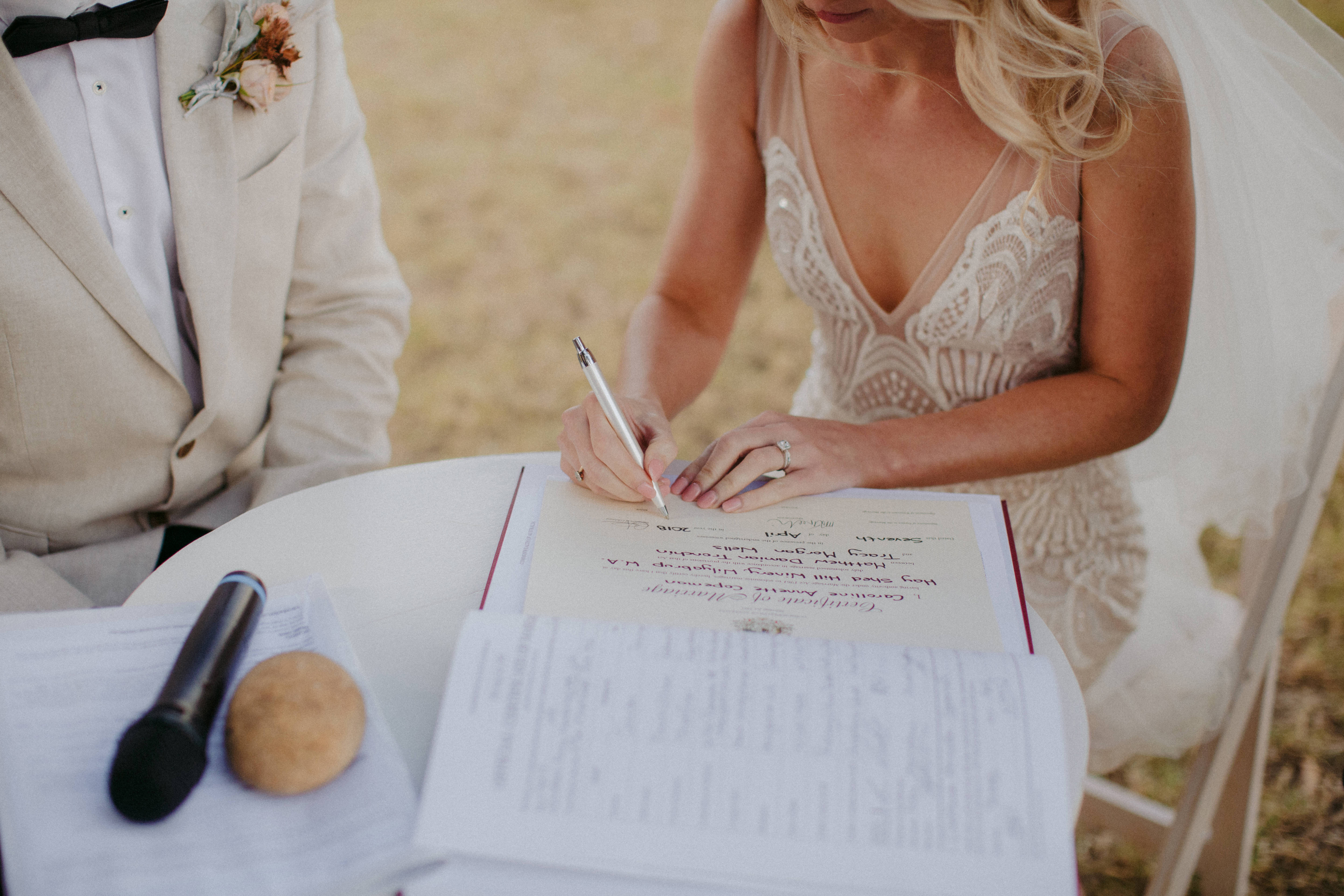 bride signing wedding certificate